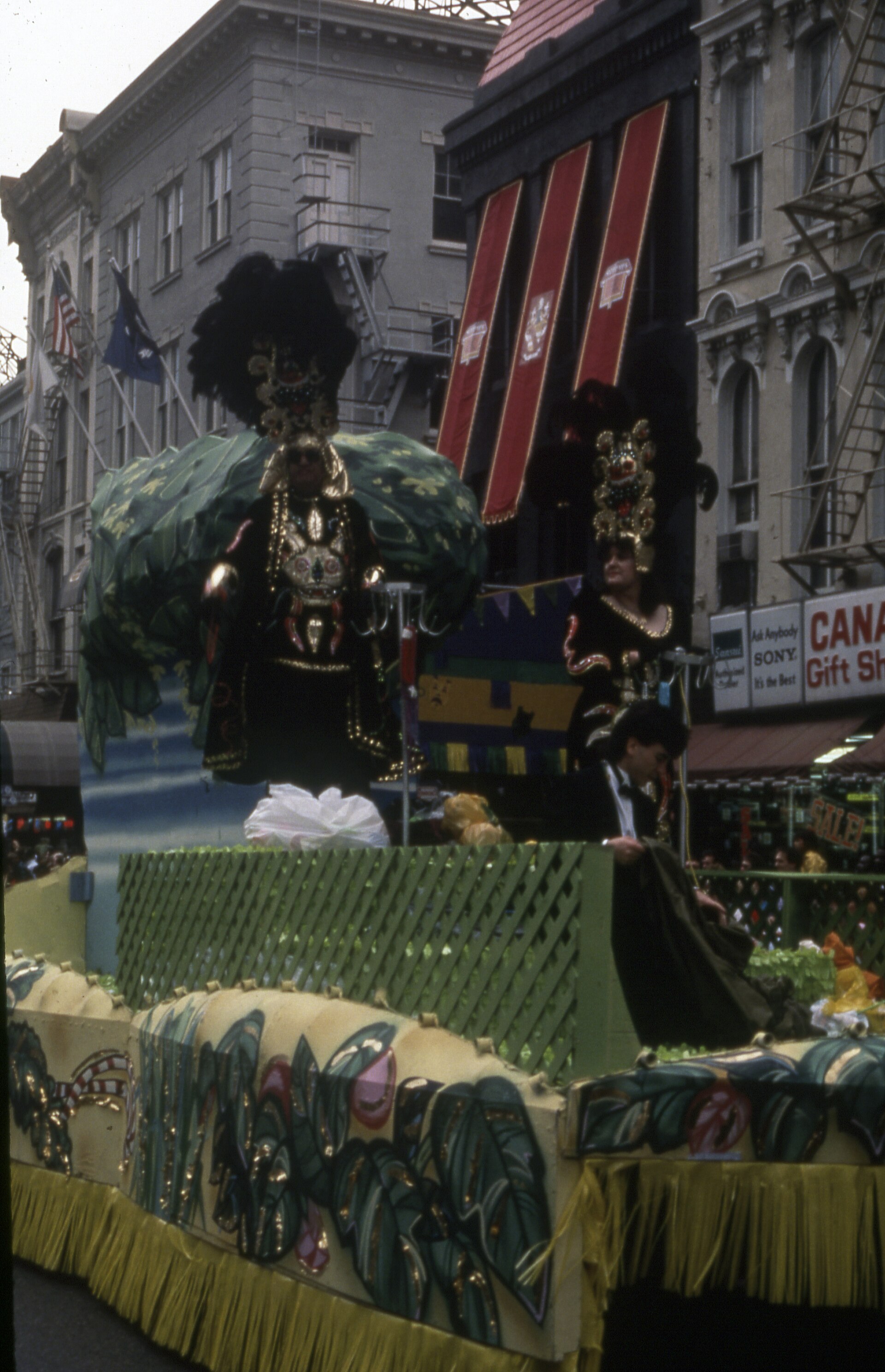 Colourful Mardi Gras parade floats moving through a packed street in New Orleans